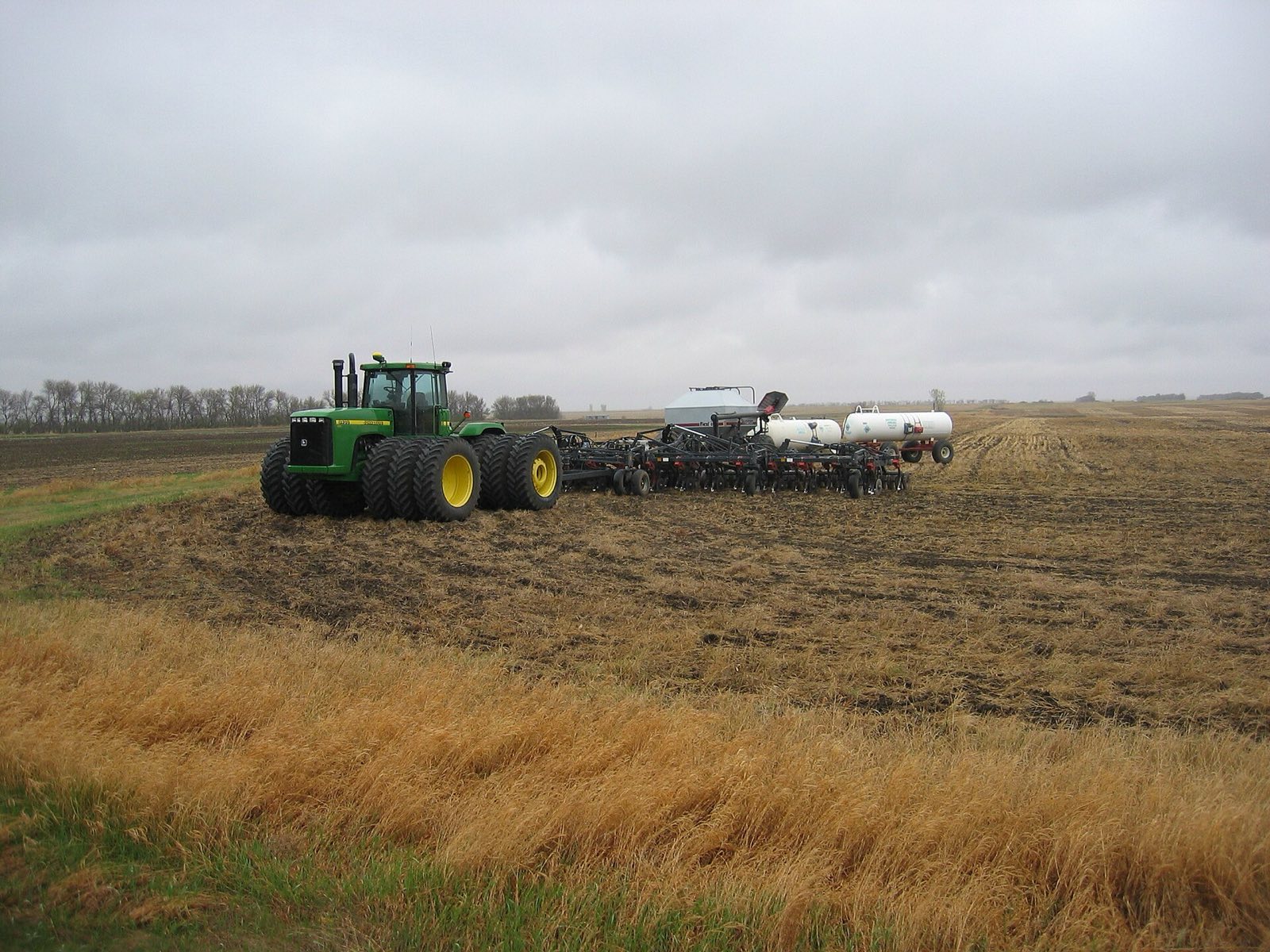 Modern tractor and planter working a large field